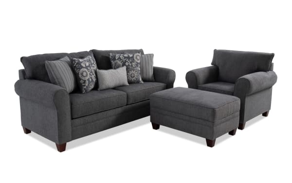 Portland Gray 85'' transitional living room set with gray polyester fabric upholstery, includes sofa, armchair, storage ottoman, and patterned accent pillows.