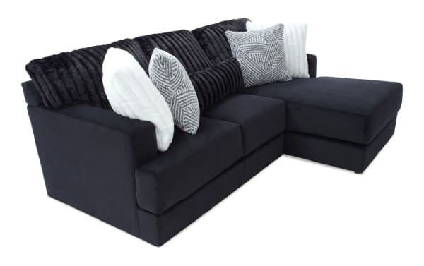 Sofia Black 98'' 2 Piece Right Arm Facing Chaise Sectional in black polyester fabric with channel tufted cushions and five faux fur pillows, transitional style.
