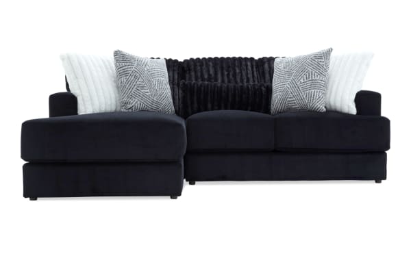 Sofia Black 98'' 2 Piece Left Arm Facing Chaise Sectional in black polyester fabric with transitional style, featuring channel tufted back cushions and five faux fur pillows for luxury and comfort.
