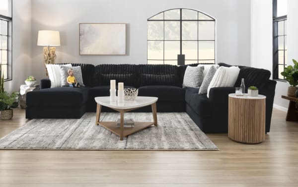 Sofia Black 98'' 2 Piece Left Arm Facing Chaise Sectional in black polyester fabric with channel tufted back cushions, five faux fur pillows, and gel memory foam seating in a transitional style.