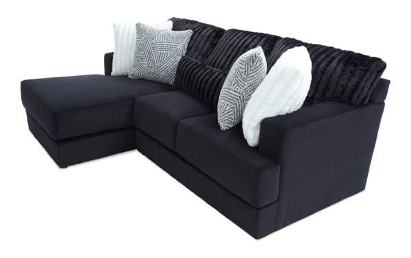 Sofia Black 98'' 2 Piece Left Arm Facing Chaise Sectional in black polyester fabric, transitional style with channel tufted back cushions and five faux fur pillows for luxury and comfort.