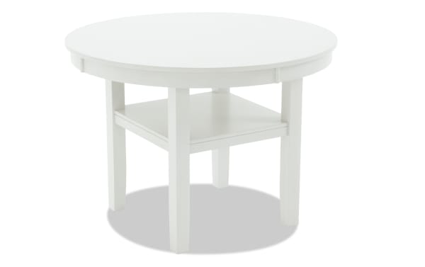 Round white MDF dining table with a beige polyester fabric shelf, part of the London Dining collection, featuring a contemporary style and sturdy design.