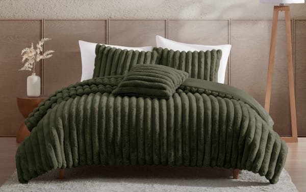 Luxurious dark green plush ribbed comforter set on a modern bed with matching pillows, soft textured bedding for cozy bedroom decor.