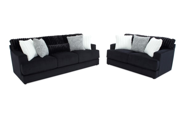 Contemporary Sofia Black 93'' Sofa and 70'' Loveseat set in black polyester fabric with channel tufted back cushions and multiple accent pillows for added comfort.
