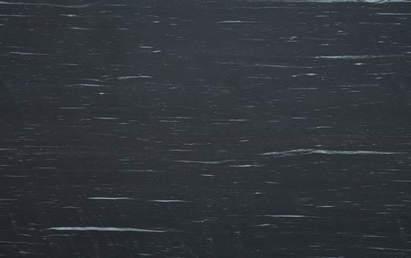 Dark charcoal gray textured wood grain background with subtle horizontal streaks and natural wood patterns, suitable for design or decor projects.
