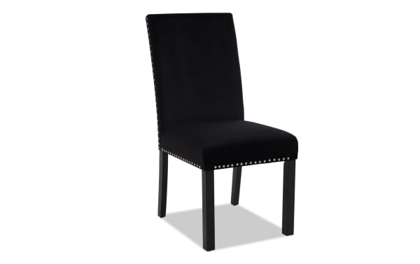 Black upholstered dining chair with high back, silver nailhead trim, and dark wooden legs, suitable for modern interiors.