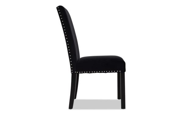Black upholstered dining chair with high back, silver nailhead trim, cushioned seat, and dark wooden legs, suitable for modern interiors.