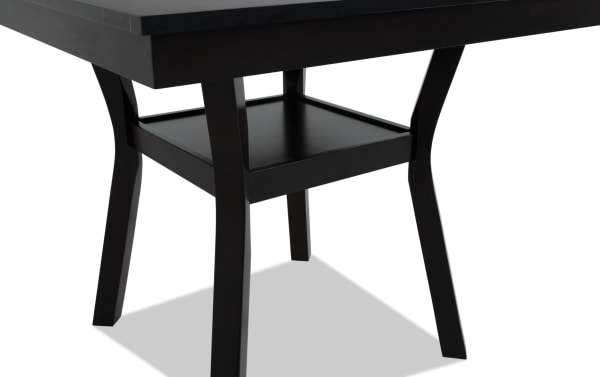 Dark wood table leg with a square lower shelf, featuring a modern design with slightly curved legs and a smooth finish.