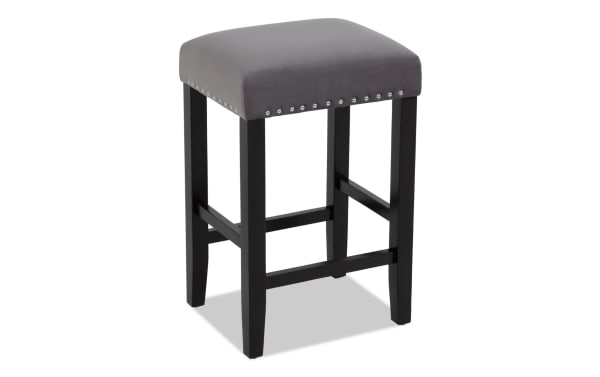 Bar stool with black wooden legs and a square gray upholstered seat featuring silver nailhead trim, suitable for kitchen or bar seating.