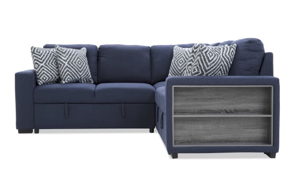 Navy blue fabric sectional sofa with corner design, featuring built-in wooden side shelves and patterned throw pillows, ideal for modern living rooms.