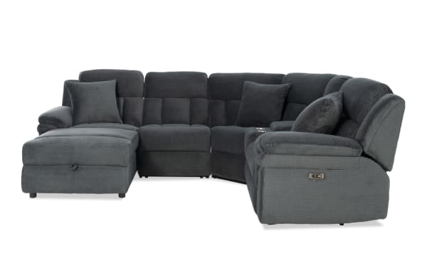 Dark gray fabric sectional sofa with plush cushions, reclining seats, and a chaise lounge, designed for comfort and modern living rooms.