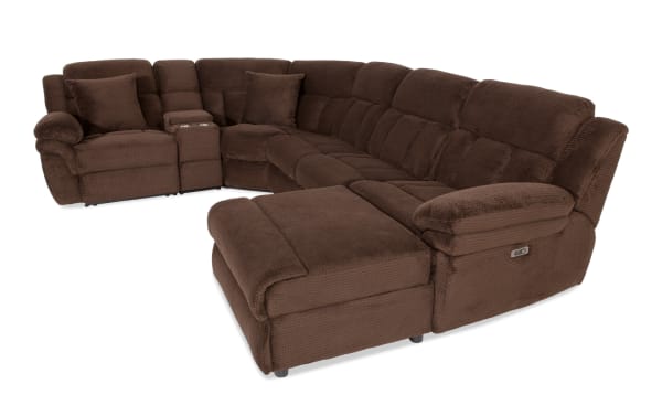 Large brown fabric sectional sofa with plush cushions, reclining seats, cup holders, and matching pillows, designed for living room comfort.