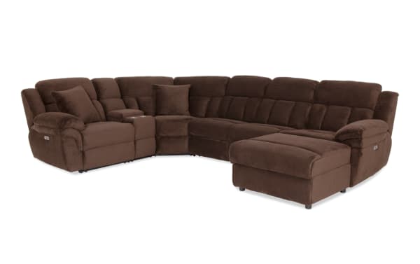 Brown sectional reclining sofa with plush cushions, corduroy fabric upholstery, built-in cup holders, and an ottoman for living room comfort.