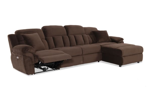 Brown fabric sectional sofa with plush cushions and two matching pillows, featuring a left-side recliner and right-side chaise lounge for living room comfort.