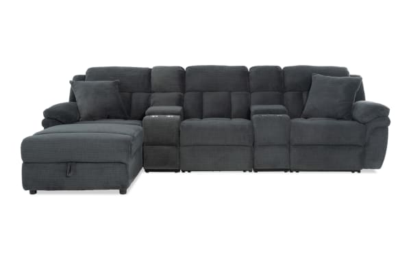 Dark gray fabric sectional sofa with chaise lounge, plush cushioning, two cup holders, and two matching throw pillows, designed for living room comfort.