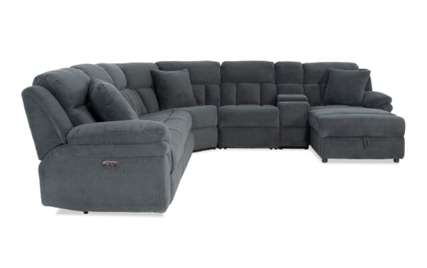 Dark gray sectional recliner sofa with textured fabric upholstery, plush cushions, and a chaise lounge, designed for modern living rooms.