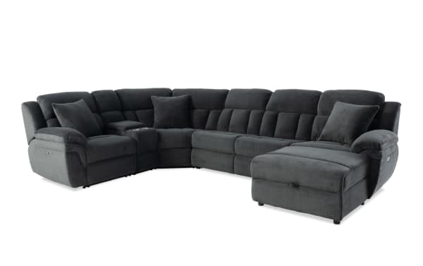 Dark gray fabric sectional sofa with plush cushions, reclining seats, and a chaise lounge, designed for modern living rooms.