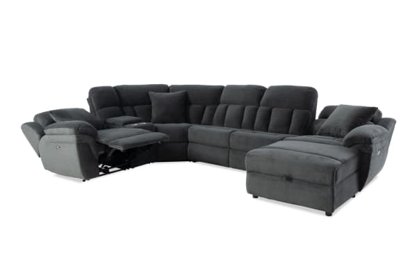 Dark gray fabric sectional sofa with plush cushioning, reclining seat, and chaise lounge, designed for comfort and modern living rooms.