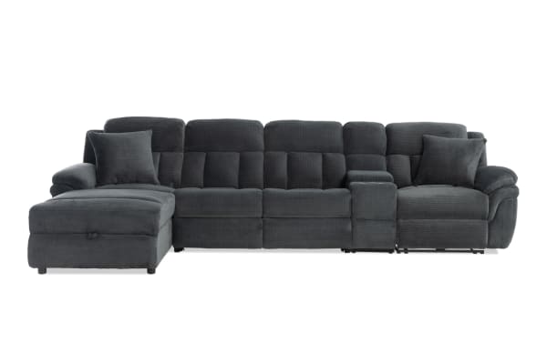 Dark gray fabric sectional sofa with chaise lounge, plush cushioning, padded armrests, and two matching throw pillows, modern style.