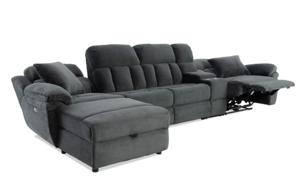 Dark gray fabric sectional sofa with plush cushions, adjustable reclining seat, chaise lounge, and built-in cup holders for living room comfort.