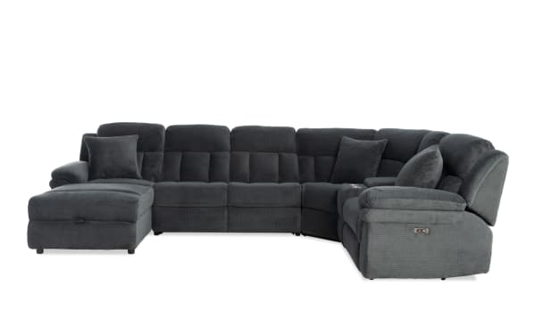 Dark gray fabric sectional sofa with plush cushions, reclining seats, and a left-side chaise lounge, designed for modern living rooms.