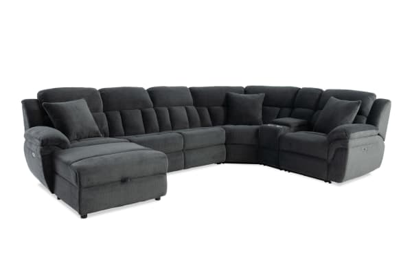 Dark gray fabric sectional sofa with plush cushions, reclining seats, and corner console, designed for modern living rooms.