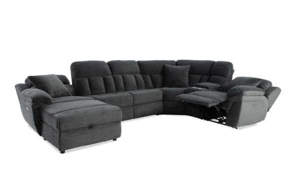 Dark gray fabric sectional sofa with plush cushions, reclining seats, and a chaise lounge, designed for comfort and modern living rooms.