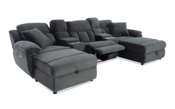 Dark gray fabric sectional sofa with plush cushions, reclining seats, cup holders, and chaise lounges, designed for living room comfort.