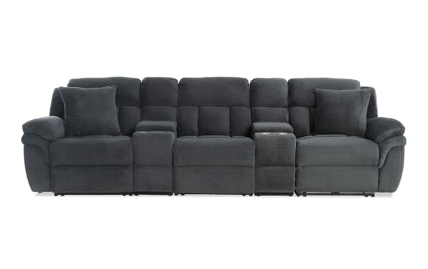 Dark gray fabric reclining sectional sofa with plush cushions, two cup holders, and padded armrests, designed for living room comfort and style.