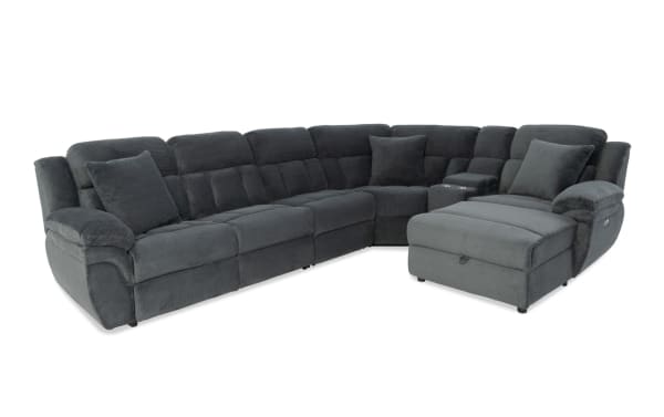 Dark gray fabric sectional sofa with plush cushions, reclining seats, cup holders, and chaise lounge, designed for comfort and modern living rooms.