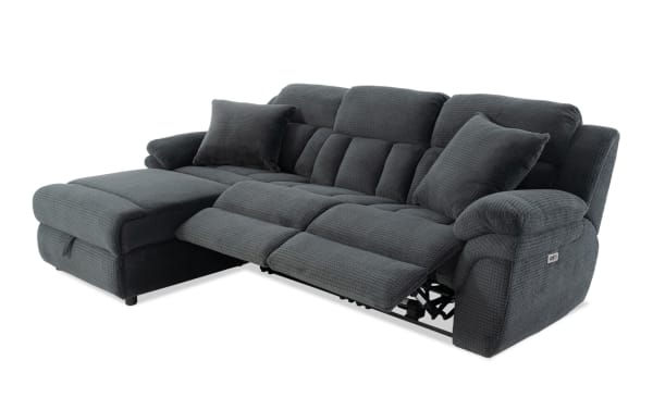 Dark gray fabric reclining sectional sofa with chaise lounge, plush cushioning, and two matching throw pillows, designed for comfort and style.