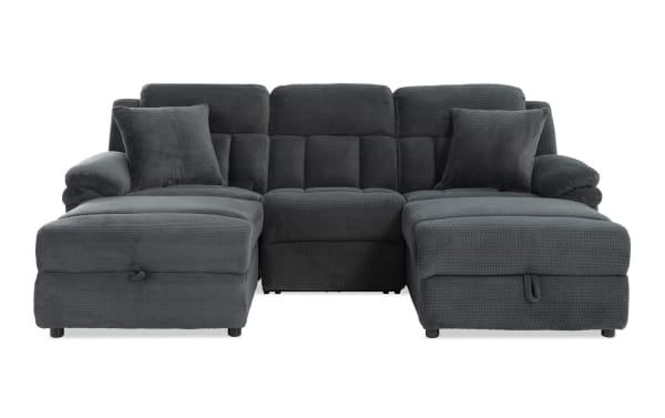 Dark gray sectional sofa with plush fabric upholstery, two matching throw pillows, and padded armrests, designed for modern living rooms.