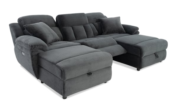 Dark gray fabric sectional sofa with plush cushions, padded armrests, and reclining chaise lounge sections, designed for comfort and modern living rooms.