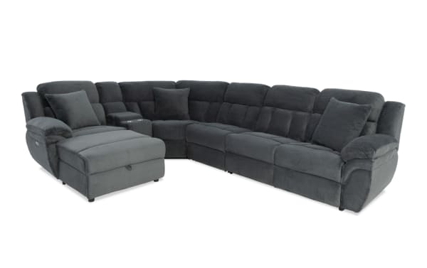 Dark gray fabric sectional sofa with plush cushions, reclining chaise lounge, cup holders, and soft armrests, designed for living room comfort.