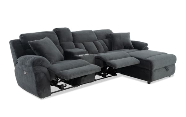 Dark gray fabric reclining sectional sofa with plush cushions, two cup holders, and a chaise lounge for living room comfort and style.