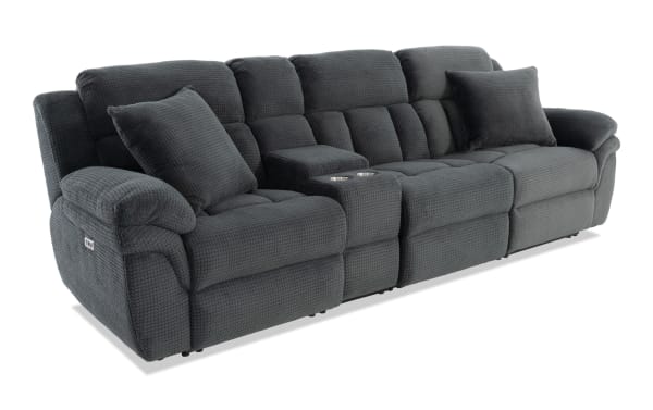 Dark gray textured fabric reclining sectional sofa with two cup holders, plush cushions, and wide padded armrests.