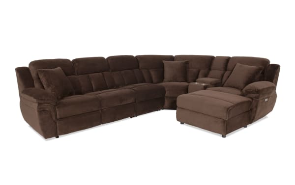 Brown sectional sofa with plush corduroy fabric, reclining seats, cup holders, and cushioned armrests, designed for living room comfort.