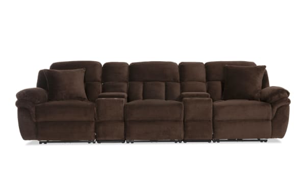 Dark brown plush fabric reclining sectional sofa with padded armrests, cushioned backrests, and two matching throw pillows.