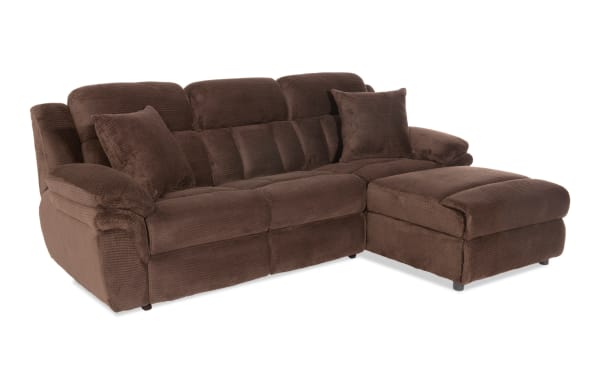 Brown sectional sofa with plush corduroy fabric, padded armrests, cushioned backrests, and two matching throw pillows, ideal for living room comfort.