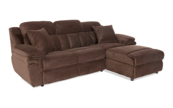 Brown sectional sofa with plush corduroy fabric, padded armrests, cushioned backrests, and matching throw pillows, ideal for living room comfort.