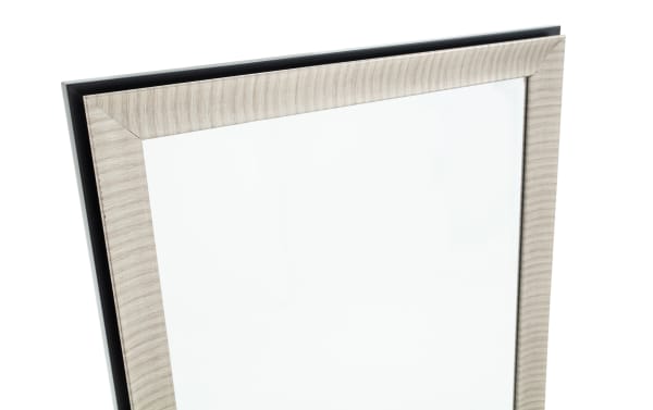 Close-up of a modern rectangular mirror with a light wood grain textured frame and a black backing panel, suitable for home decor.