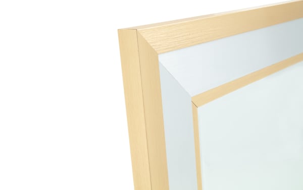 Close-up of a brushed gold metal picture frame corner with a beveled edge, showcasing its smooth texture and modern style.