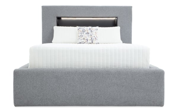 Contemporary Playday Queen gray upholstered storage platform bed with polyester fabric, padded headboard, built-in bookshelf, and footboard drawer.