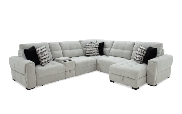 Slider Bob Gray 131" power sliding 6-piece right arm facing chaise sectional in gray polyester fabric. Transitional style with tufted cushions, built-in cup holders, USB/USB-C ports, cozy accent pillows, and hidden storage for comfort and convenience.