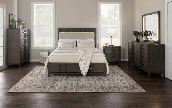 Transitional Laguna 5 Piece Queen Bedroom Set in gray pine solids and polyester fabric, featuring upholstered storage platform bed with LED lighting, dark brown wood veneer dresser, nightstand, and chest with dovetail joints and felt-lined drawers.