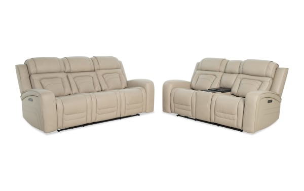 Beige leather reclining sofa set with three-seat and two-seat sections, featuring padded armrests and headrests, modern style for living room seating.