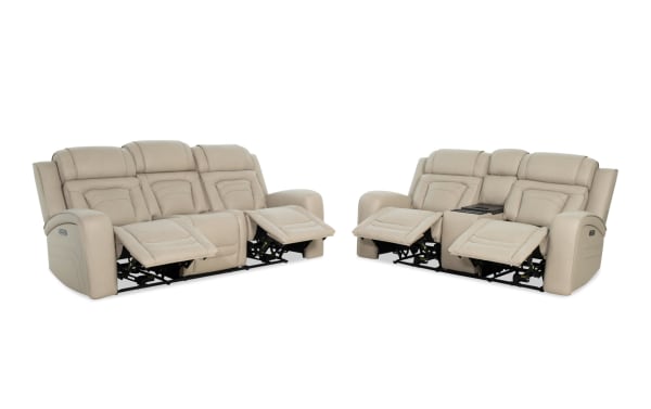 Beige leather reclining sofa set with three seats on the left and two seats with center console on the right, featuring padded armrests and headrests.