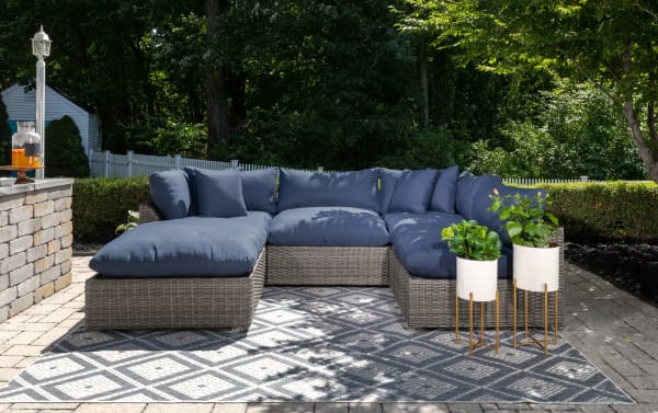 Gray Dream 5 Piece Outdoor Sectional in transitional style with all-weather wicker, aluminum frame, reversible polyester cushions, and modular design.