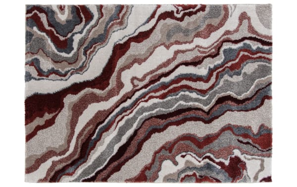 Abstract area rug with a wavy, marbled pattern in shades of burgundy, gray, beige, and white, featuring a plush textured surface suitable for modern home decor.