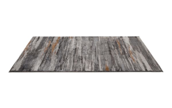 Rectangular area rug with abstract linear pattern in shades of gray, taupe, and rust orange, featuring a soft textured surface suitable for modern home decor.